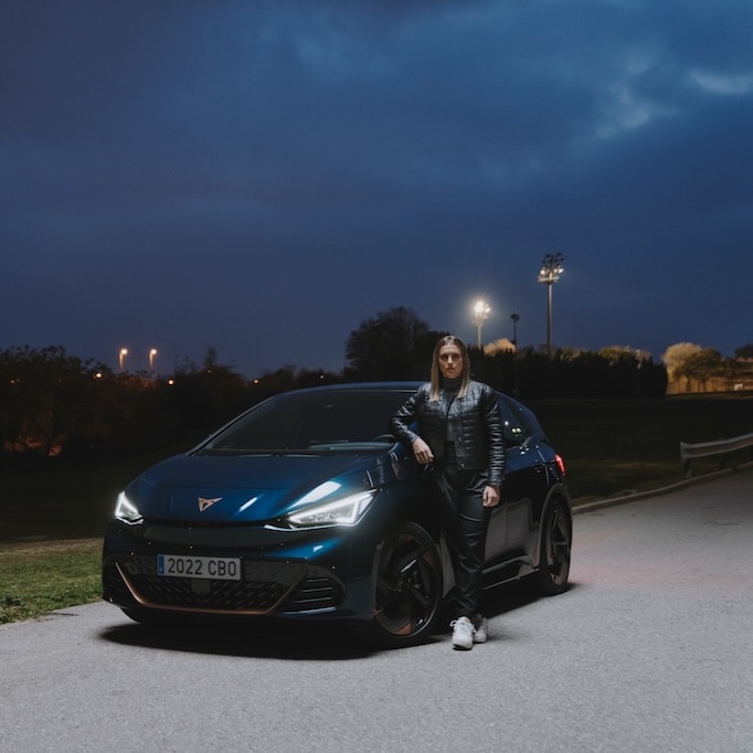 Alexia Putellas leaning on a CUPRA Born in Aurora Blue colour