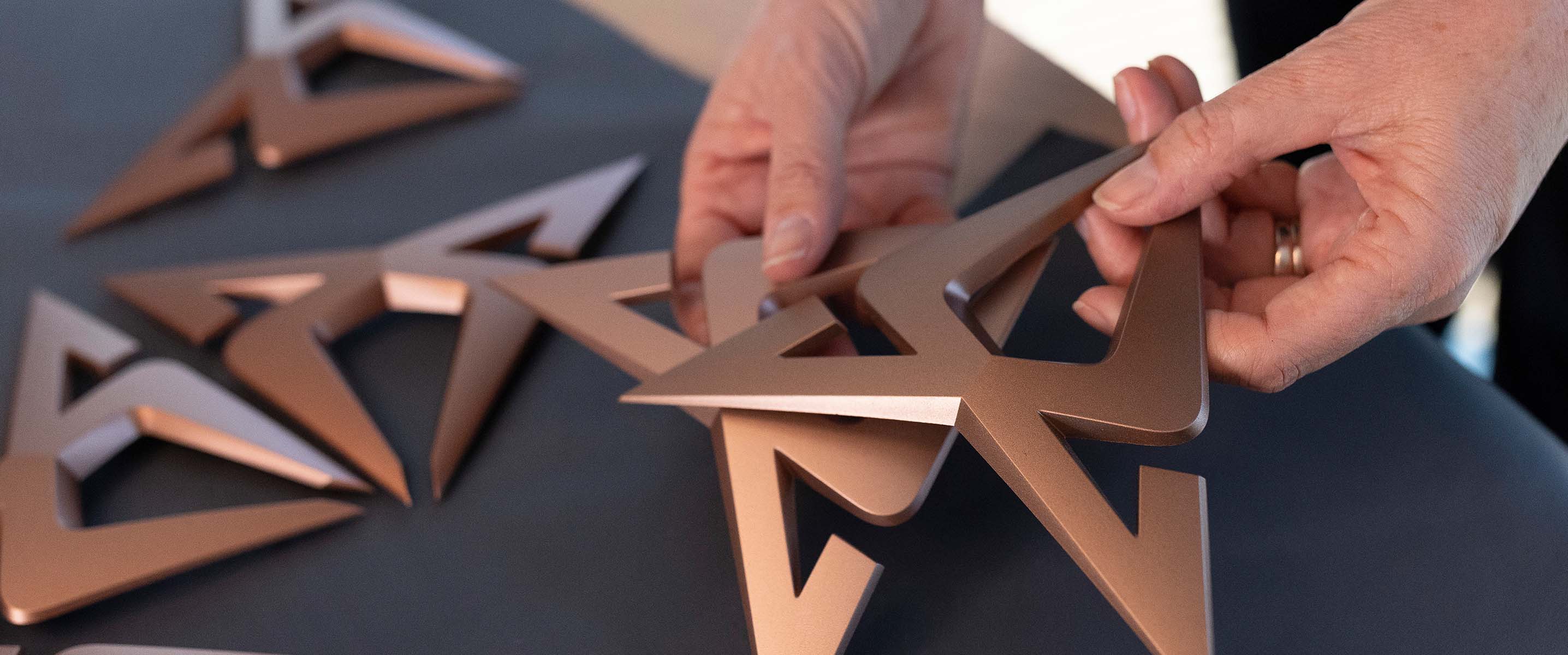 Francesca Sangalli selecting copper CUPRA emblem logos for the CUPRA Tavascan.