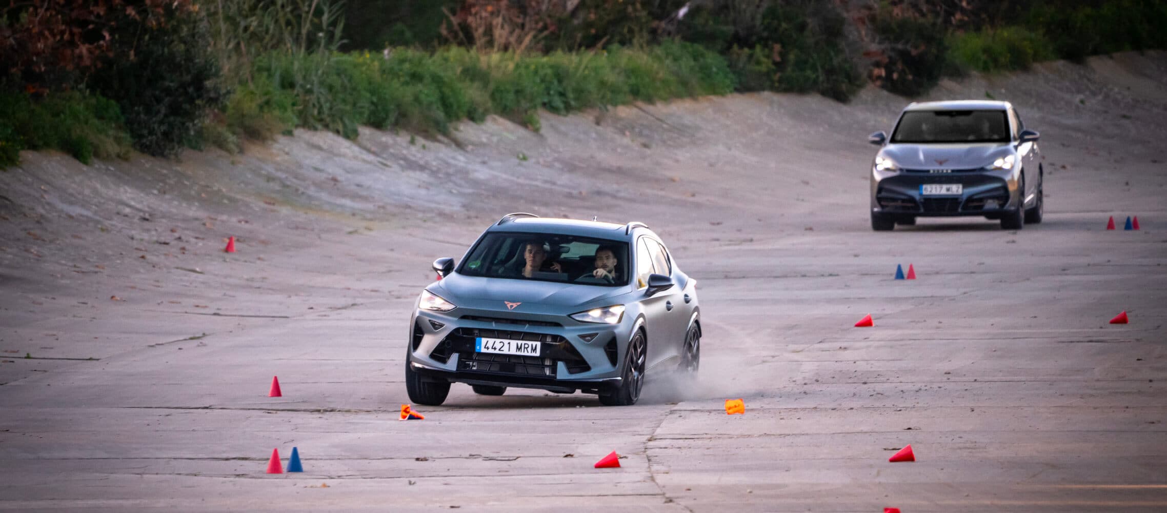 Raphinha, FC Barcelona player, sits in the driver’s seat of a car, looking straight ahead. 