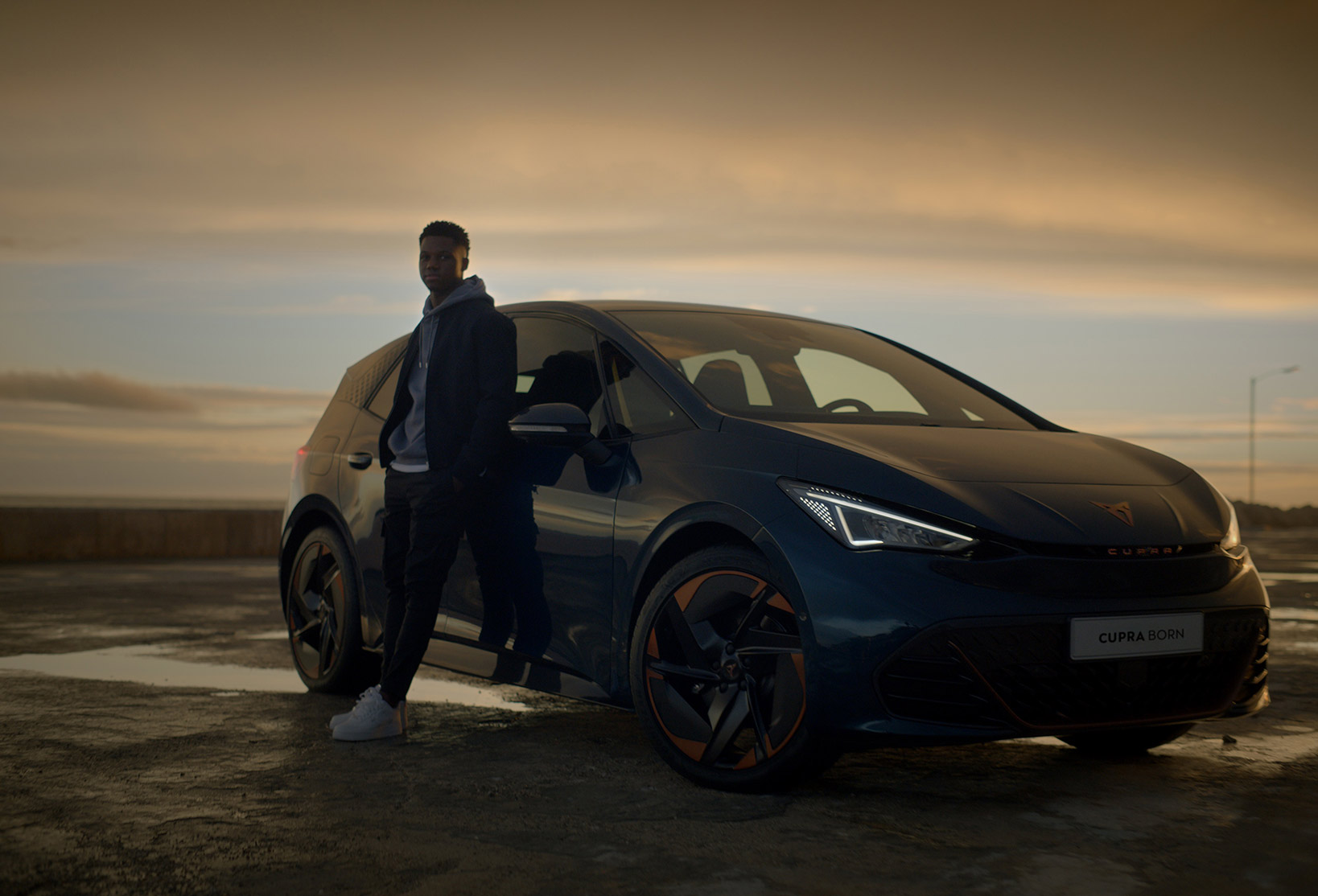 he Barcelona football player, Ansu Fati stands with the first electric car of the CUPRA brand, the CUPRA Born
