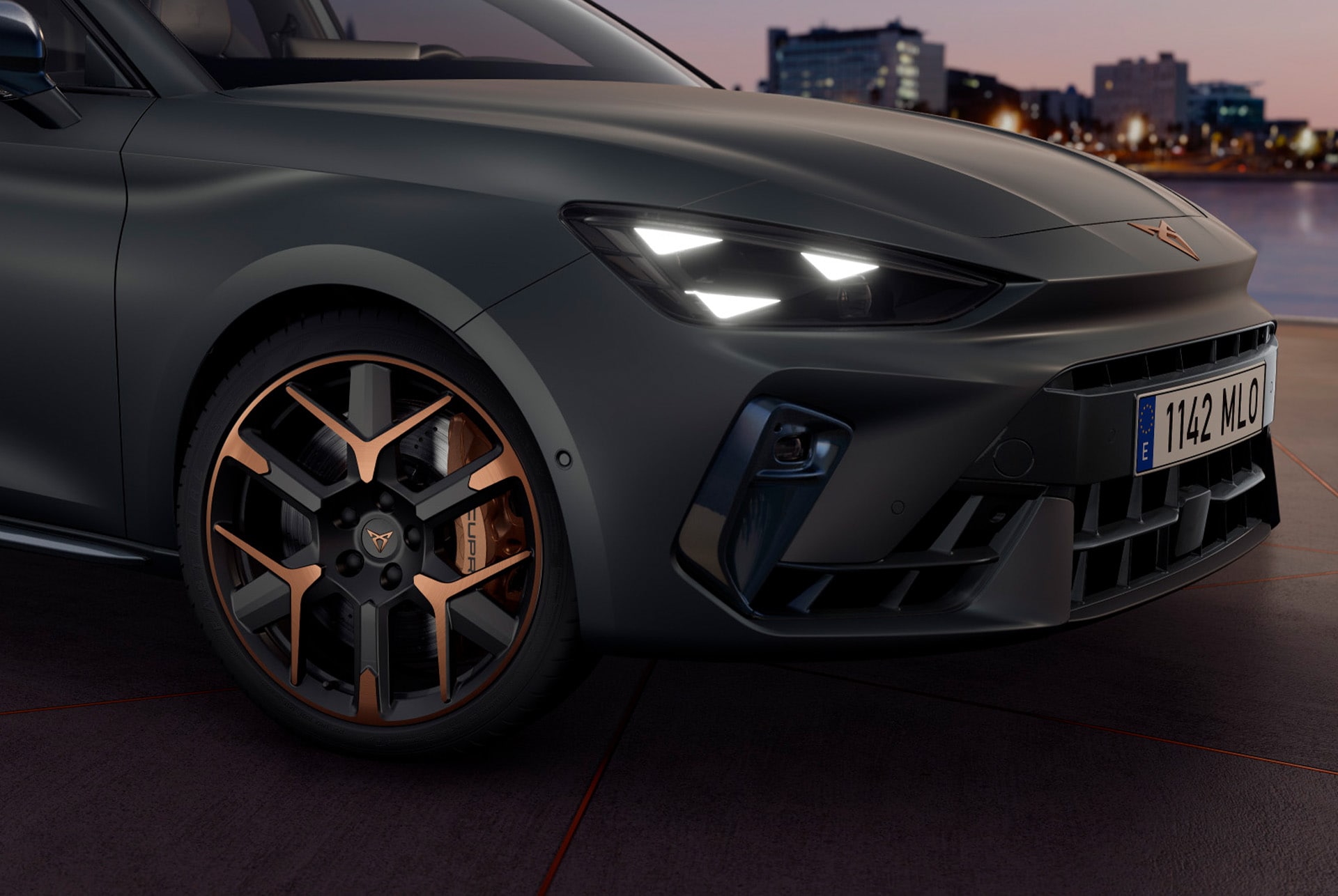 new cupra leon sportstourer 2025 close up of copper accent and black wheel and triangle eye cupra headlight, enceladus grey matt car body