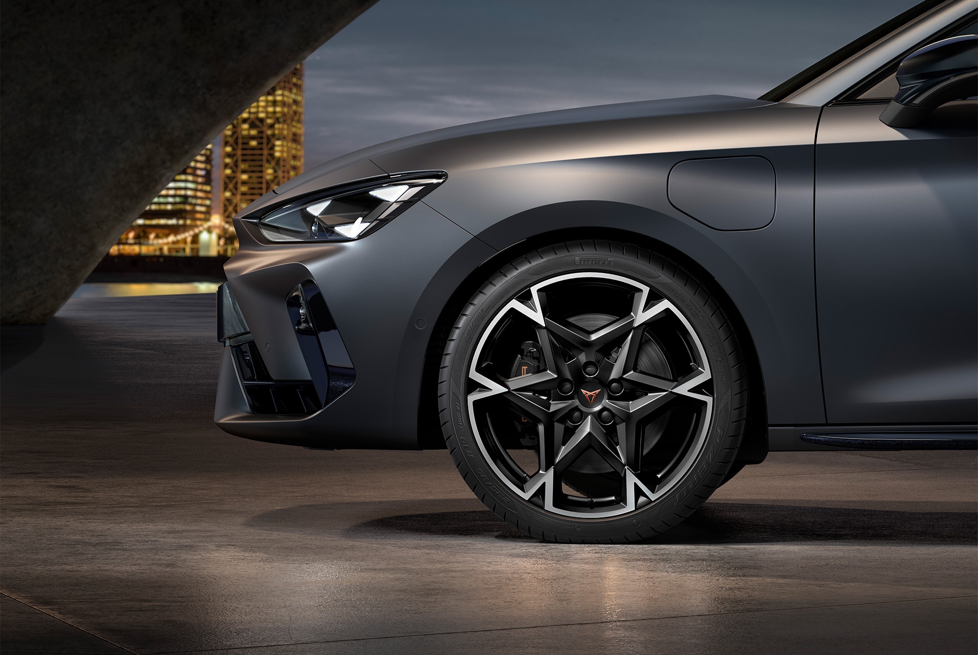 front side view of left machined polar alloy wheel in black and silver for the new Cupra Leon 2025, tyres, signature headlights and grey body.