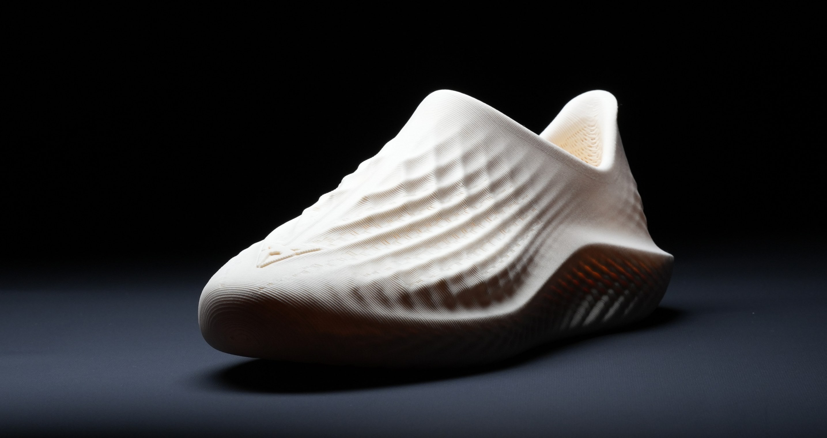 A white, textured shoe displayed in a product shot against a background.