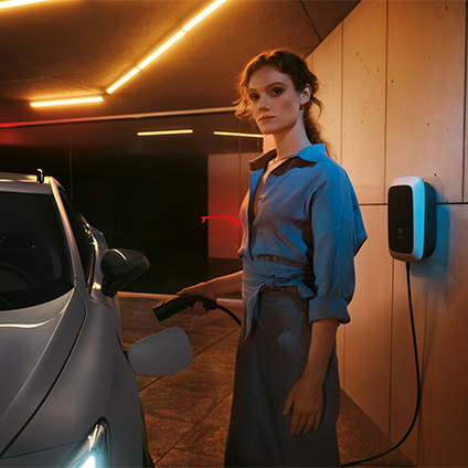 woman charging hybrid cupra formentor with the elli charger for hybrid and electric vehicles