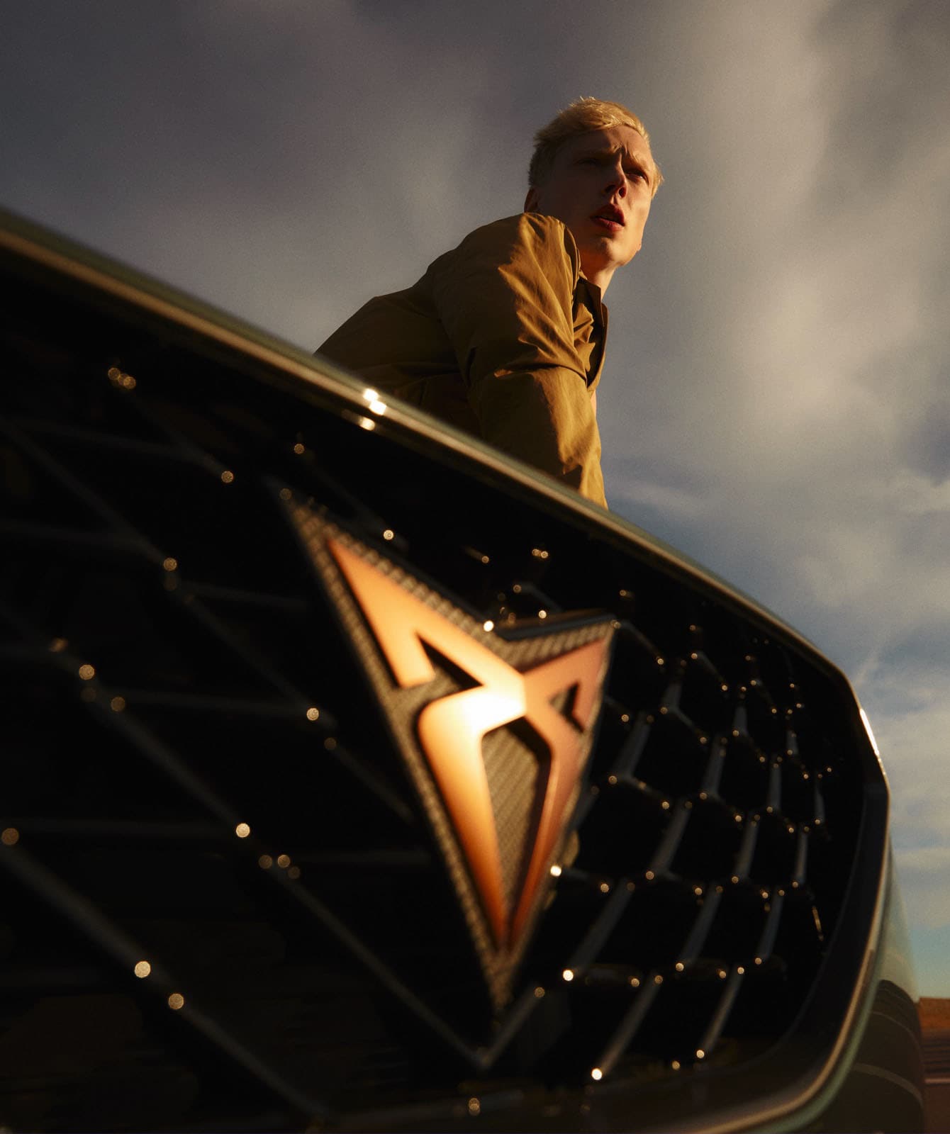 man-next-to-cupra-formentor-with-copper-logo