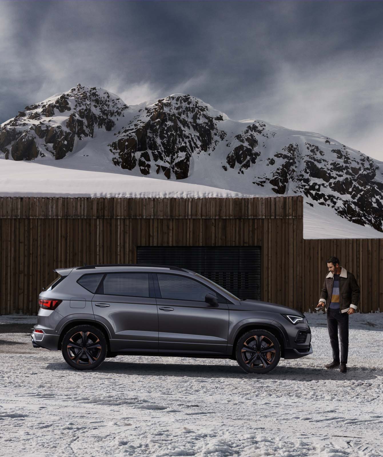 man-in-front-of-cupra-ateca-mountain-snow-view