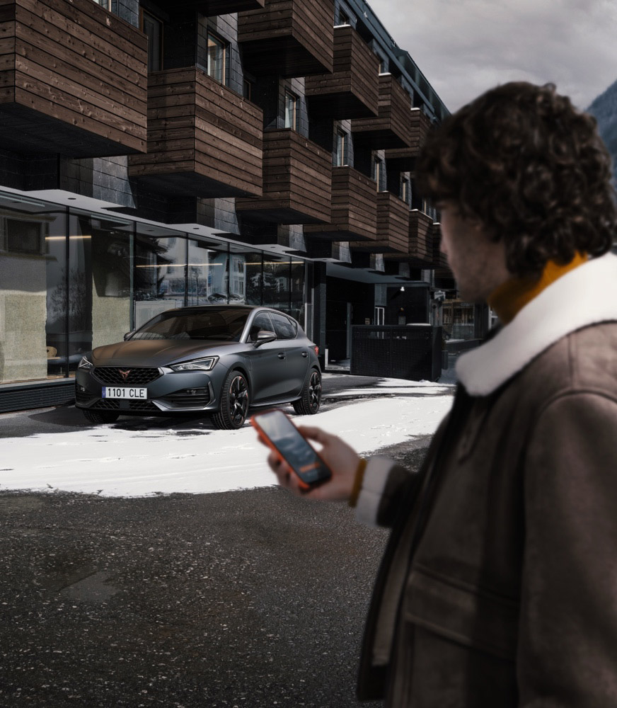 man-in-front-of-apartments-with-phone