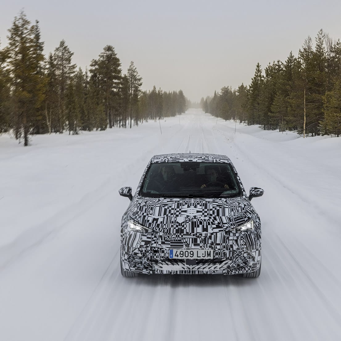 A CUPRA Born doing a winter test on a snow-covered road